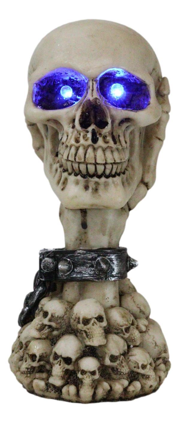 Ebros Gift Shackled Skeleton Hand Holding Skull With LED Eyes With Morphing Skulls Figurine