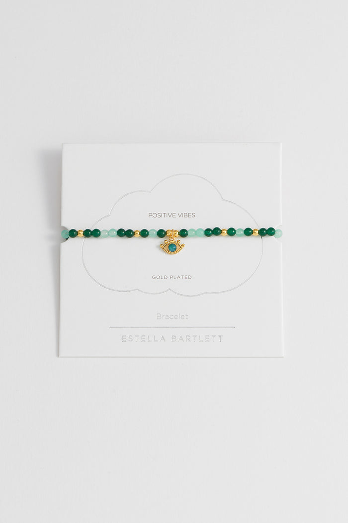 estella bartlett Beaded Evil Eye Charm Bracelet Gold Plated | Green Quartz Packaging Message: Positive Vibes