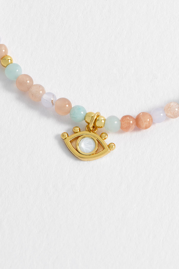 Estella Bartlett Evil Eye Charm Bracelet Gold Plated | Peach Moonstone And Lime Aventurine Packaging Message: GODDESS ENERGY