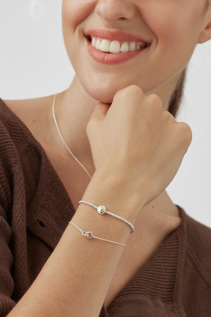 Estella Bartlett Heart Disc Bead Bracelet Silver Plated Packaging Message: All Your Need Is Love
