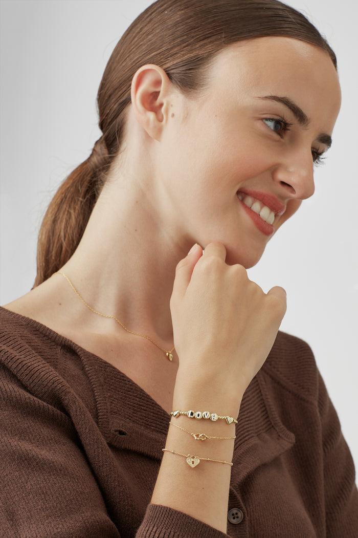 Estella Bartlett Love Letter Bead Bracelet Gold Plated Packaging Message: All Your Need Is Love