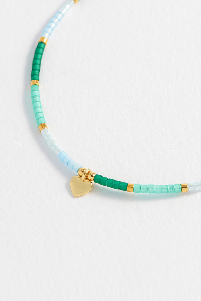 Estella Bartlett Mini Heart Miyuki Bracelet Gold Plated | Green Packaging Message: She Believed She Could So She Did