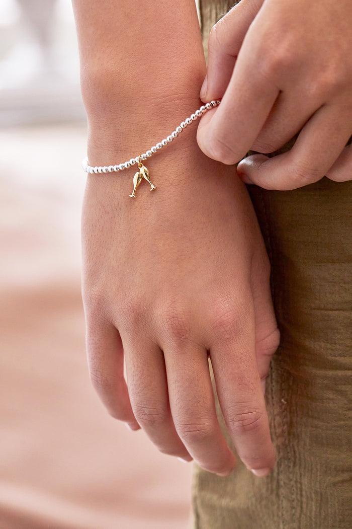Estella Bartlett Sienna Beaded Champagne Charm Bracelet Gold And Silver Plated Packaging Message: LET'S CELEBRATE