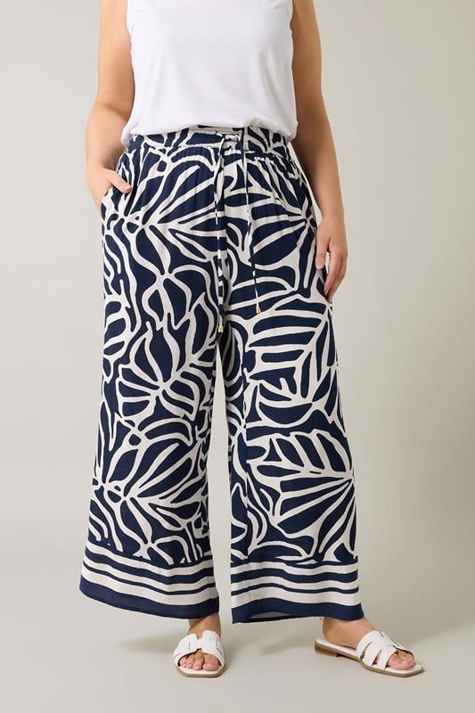 Evans EVANS Curve Navy Blue Palm Border Print Trousers