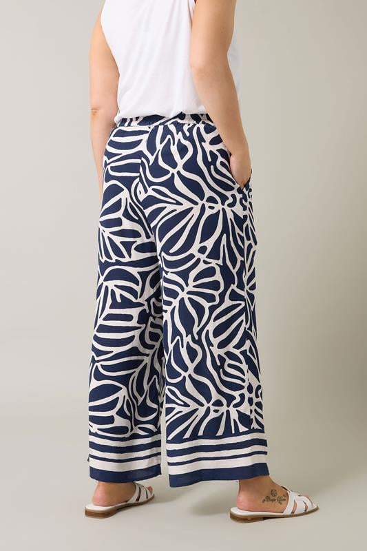 Evans EVANS Curve Navy Blue Palm Border Print Trousers