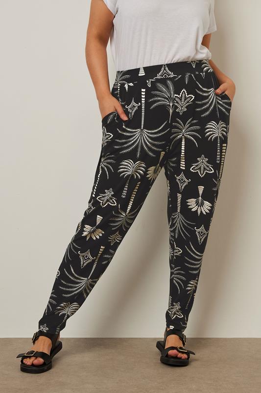 evans YOURS Curve Black Palm Print Harem Trousers