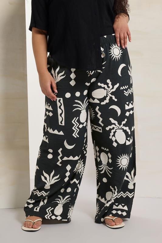 evans YOURS Curve Black Abstract Print Twill Wide Leg Trousers