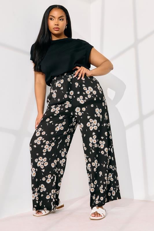 evans YOURS Curve Black Daisy Print Wide Leg Trousers