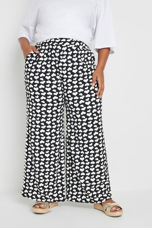 evans YOURS Curve Black Heart Print Wide Leg Trousers