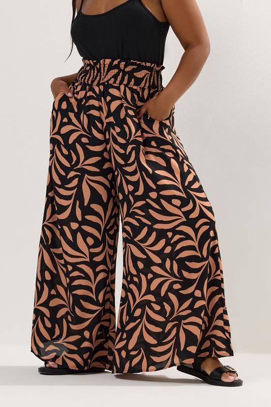 evans YOURS Curve Black Palm Leaf Shirred Waist Trousers