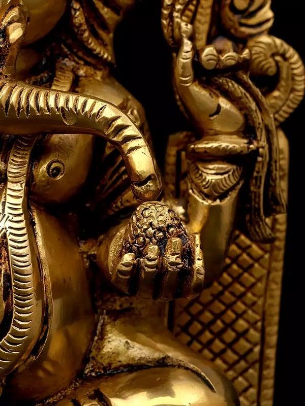 Exotic India 10" Four Armed Blessing Lord Ganesha Seated On Kirtimukha Throne | Brass Statue 