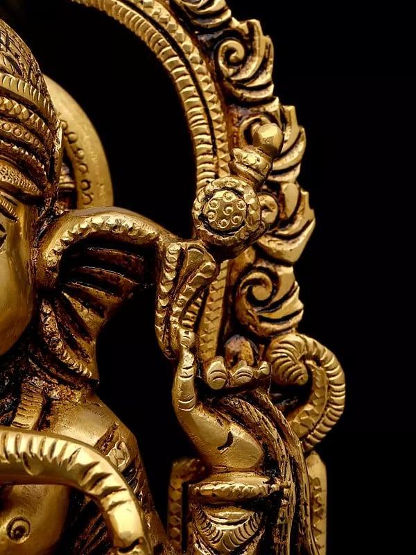 Exotic India 10" Four Armed Blessing Lord Ganesha Seated On Kirtimukha Throne | Brass Statue 