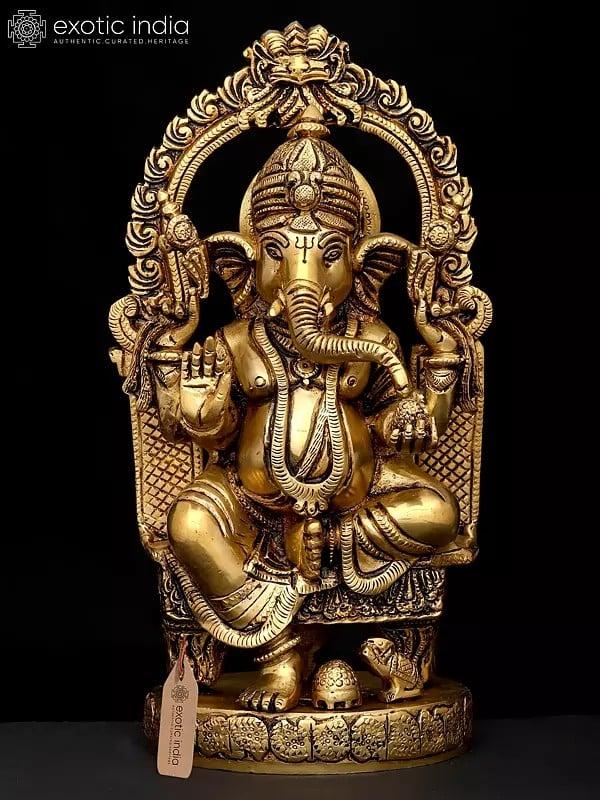 exotic india 10" Four Armed Blessing Lord Ganesha Seated on Kirtimukha Throne | Brass Statue 