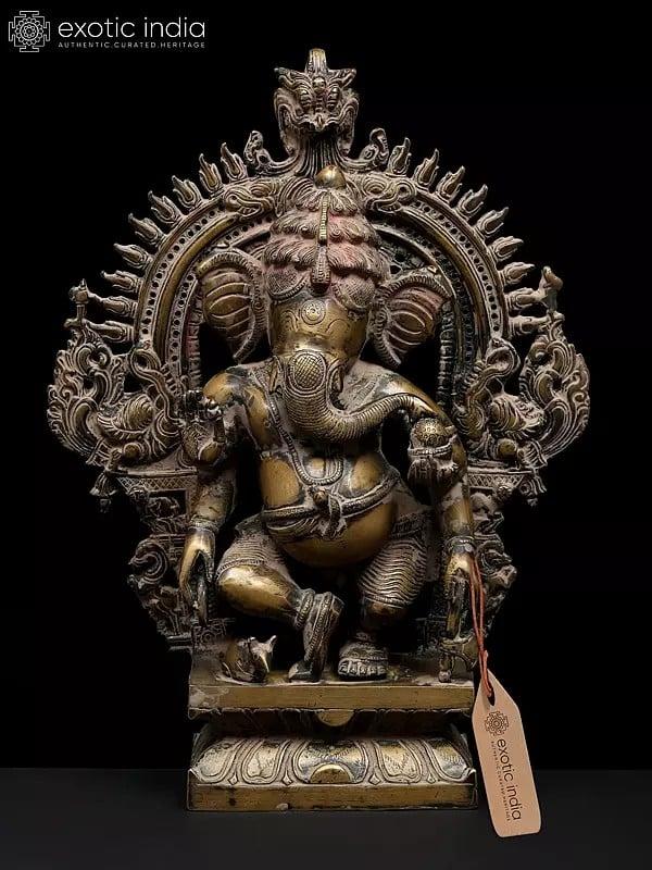 exotic india 14" Four Armed Dancing Lord Ganesha on Kirtimukha Throne | Brass Statue 