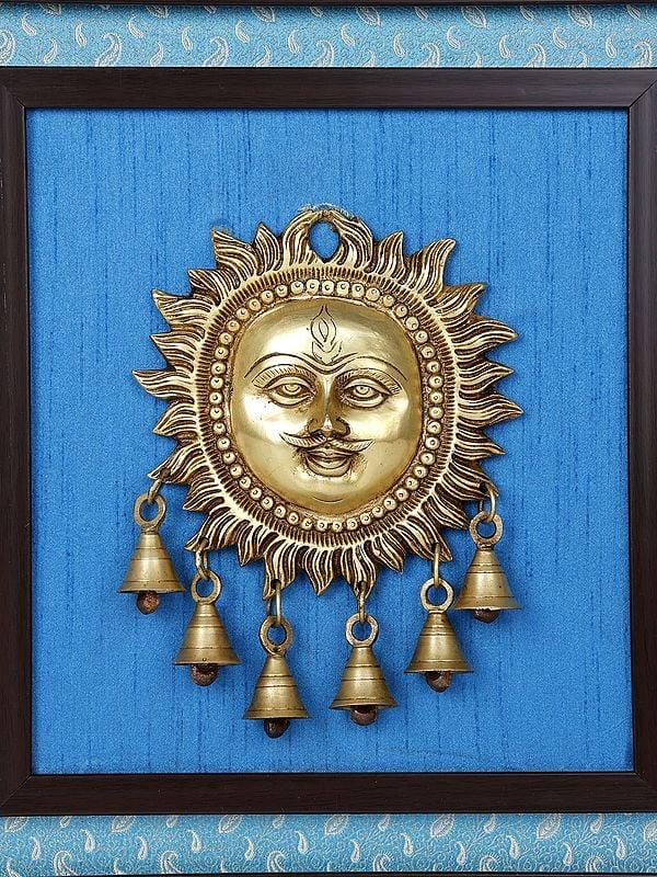 Exotic India 15" Lord Surya With Dangling Bells In Brass | Wood Framed Brass Sculpture | Wall Hanging Decor 