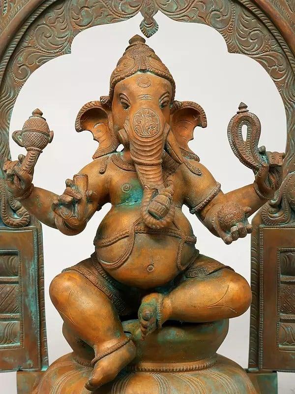 Exotic India 17" Four Armed Lord Ganesha Seated On Kirtimukha Throne | Madhuchista Vidhana (Lost-Wax) | Panchaloha Bronze From Swamimalai 