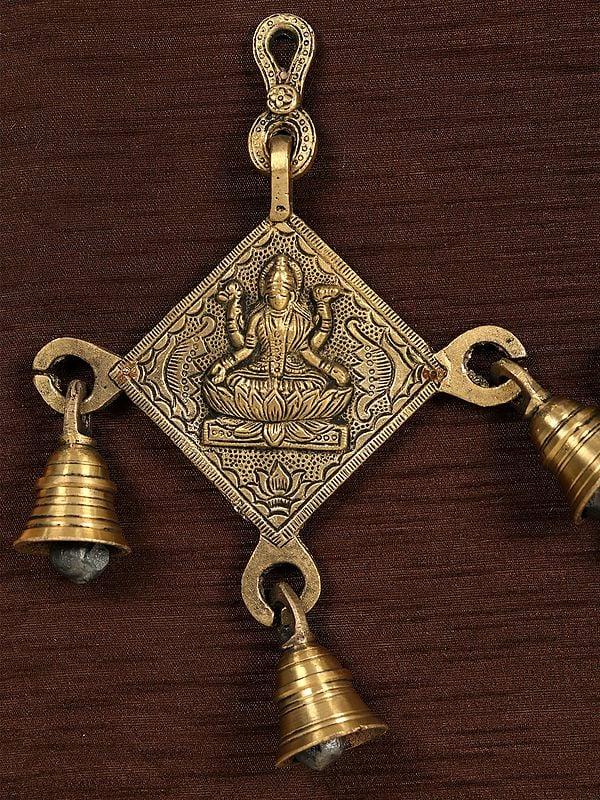 Exotic India 17" Lakshmi Ganesha And Saraswati With Bells In Brass | Wooden Wall Hanging Frame 