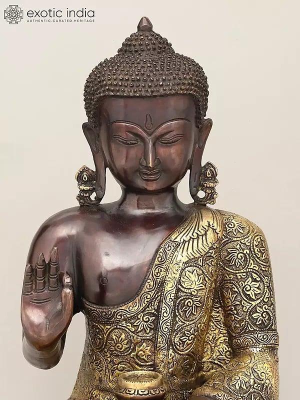 Exotic India 17" Lord Buddha Seated In Vitark Mudra With Floral Carving On Robe | Brass Statue 