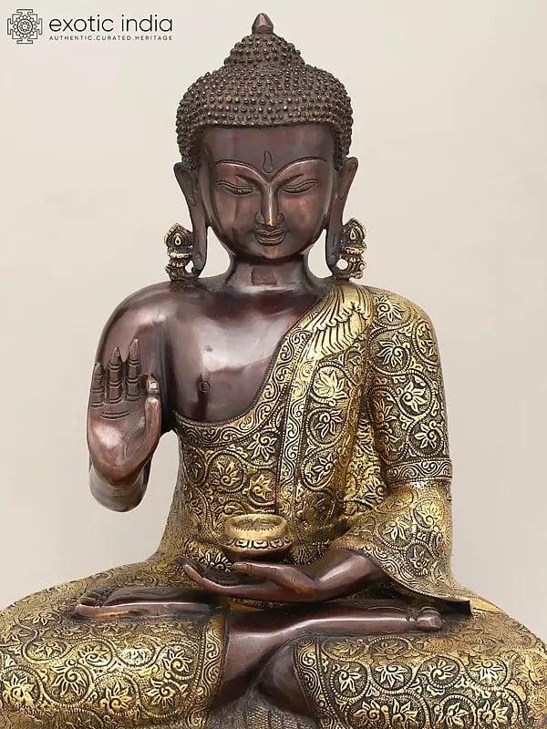Exotic India 17" Lord Buddha Seated In Vitark Mudra With Floral Carving On Robe | Brass Statue 