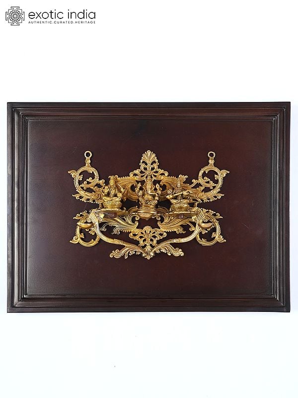 exotic india 24" Lakshmi Ganesha Saraswati with Diya | Wood Framed Brass Sculpture | Wall Hanging 