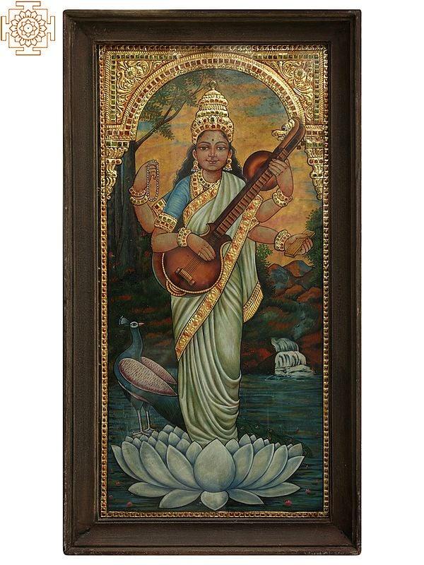 exotic india 26" Maa Saraswati Standing on White Lotus | Tanjore Painting with Frame | Art by Rajaraman