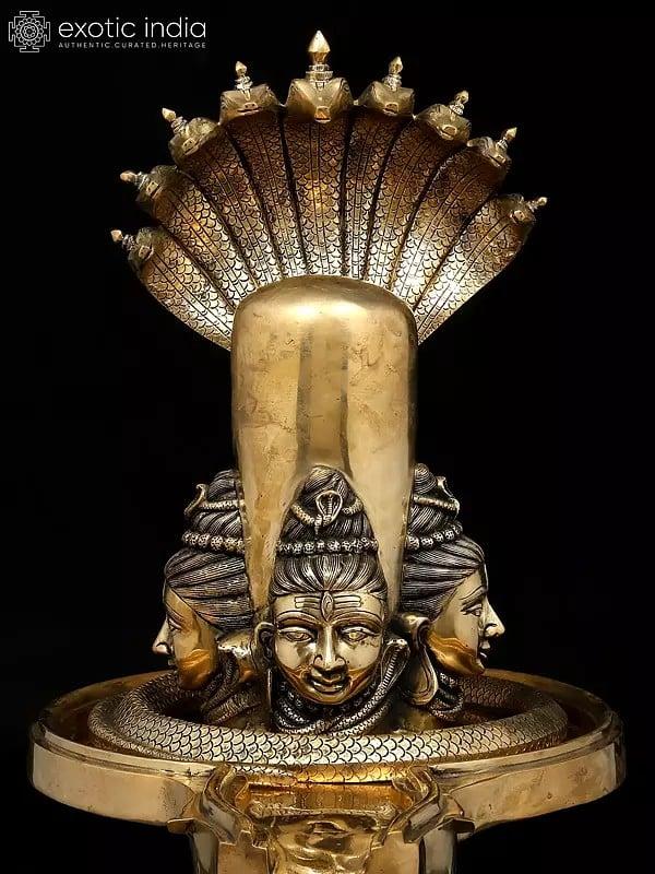 Exotic India 30" Brass Shivalingam With Four Shiva Faces And Protected By Nine Hooded Serpent 