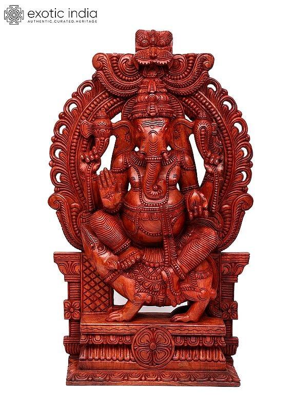 exotic india 50" Large Blessing Lord Ganesha Seated on Mushak with Kirtimukha Prabhavali | Wood Carving 