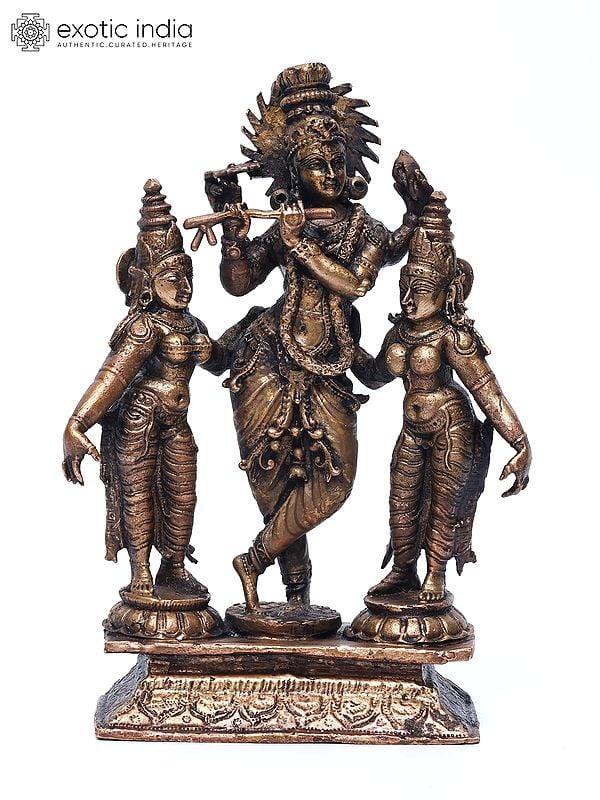 exotic india 6" Small Standing Lord Krishna with Rukmini and Satyabhama | Copper Statue 