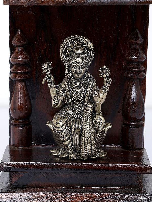 Exotic India 6" Small Superfine Goddess Lakshmi Temple | Brass Statue With Wooden Temple | Wall Hanging 