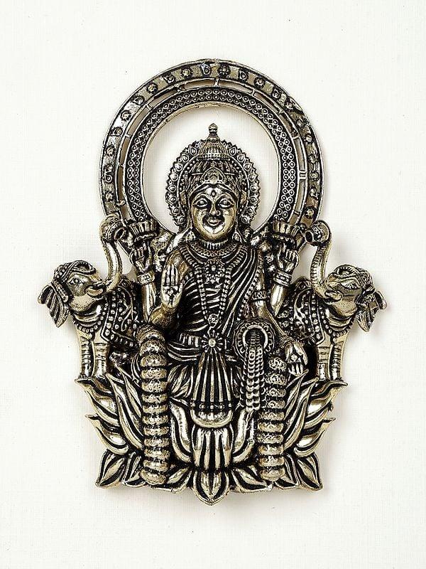 Exotic India 9" Superfine Goddess Gajalakshmi Wood Framed Brass Sculpture | Wall Hanging Statue 