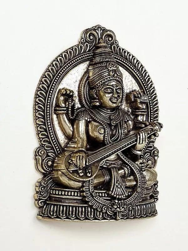 Exotic India 9" Superfine Sitting Goddess Saraswati | Wood Framed Brass Sculpture | Wall Hanging Decor 