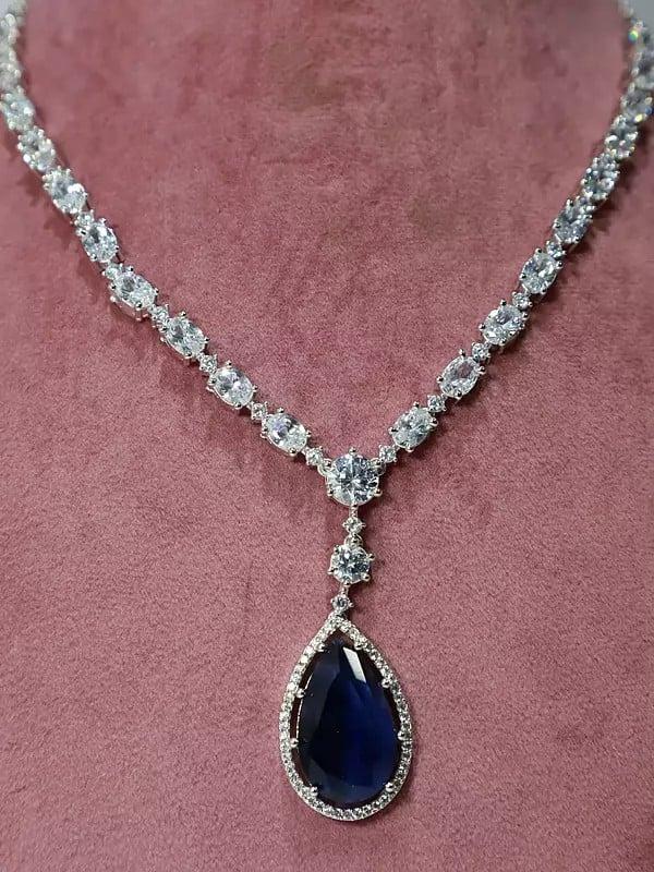 Exotic India American Diamond Set Stylish Stone Studded Pendant With Earrings