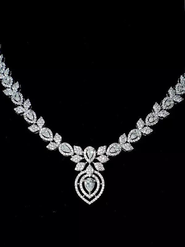Exotic India Attractive Floral Design Stone Studded American Diamond Necklace Set With Earrings