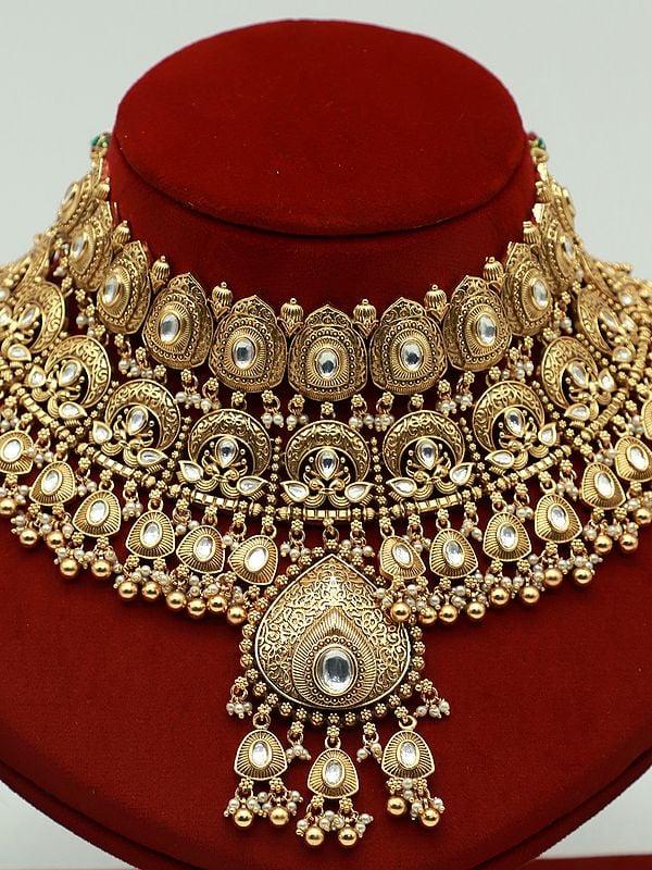Exotic India Brass Heavy Necklace Set For Bride With Attractive Carving Earrings And Elegant Mangtika 