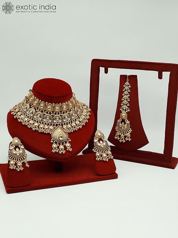 exotic india Brass Heavy Necklace Set For Bride With Attractive Carving Earrings And Elegant Mangtika