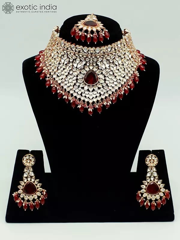 exotic india Choker Design Stone Studded And Beaded Necklace With Matching Earrings And Mangtika 
