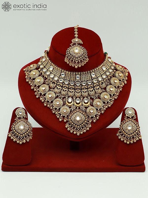exotic india Embellished Carving Necklace Set With Attractive Mangtika And Earrings 