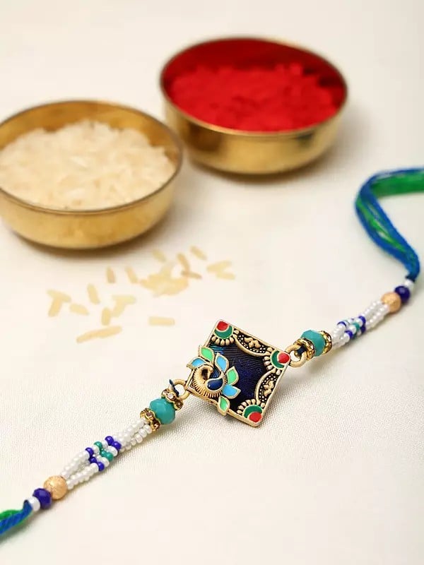 Exotic India Enamel Work Peacock Rakhi With Beads 