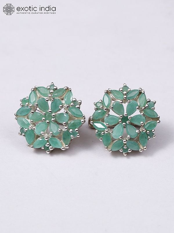 Exotic India Floral Sterling Silver Earrings With Faceted Emerald