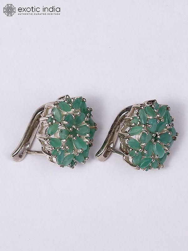 Exotic India Floral Sterling Silver Earrings With Faceted Emerald