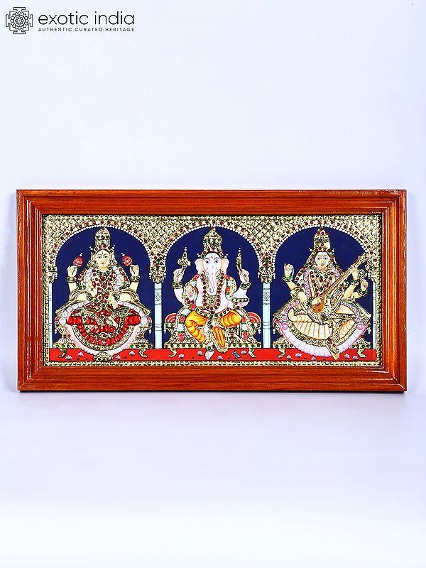 exotic india Goddess Lakshmi Lord Ganesha and Devi Saraswati | 24 Karat Gold Work | Framed Tanjore Painting