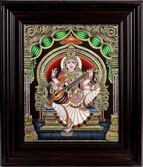exotic india Goddess Saraswati Seated in Lalitasana Wearing Sari | Framed Tanjore Painting 