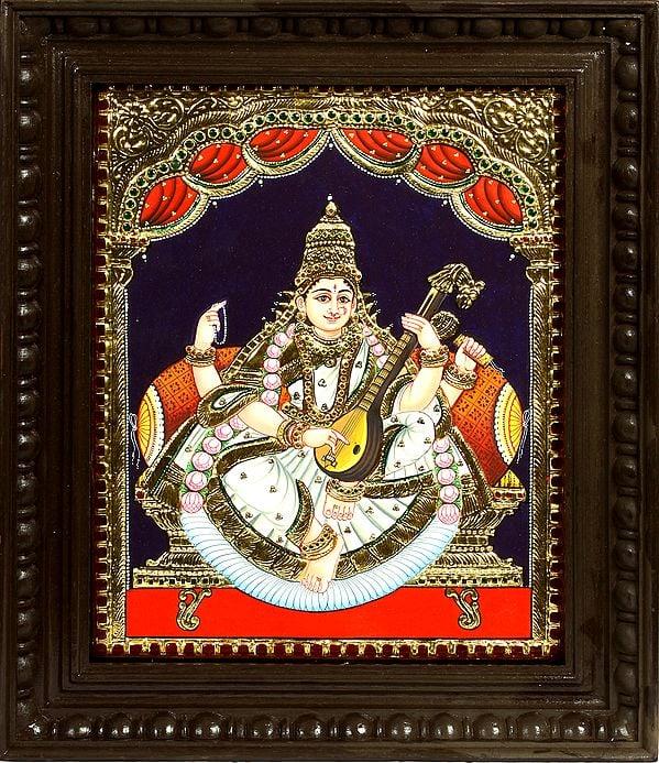 exotic india Goddess Saraswati Seated on Golden Throne Wearing White Sari | Framed Tanjore Painting 