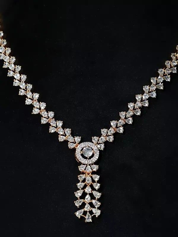 Exotic India Gold Polish Base Stone Studded Embellished American Diamond Necklace Set With Earrings