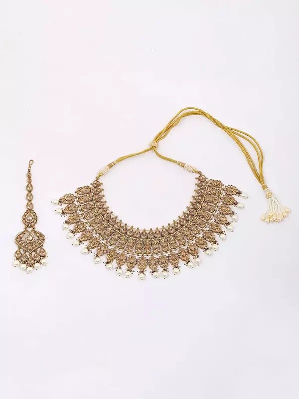 Exotic India Golden And White Stone Studded Necklace Set With Earrings And Mangtika 