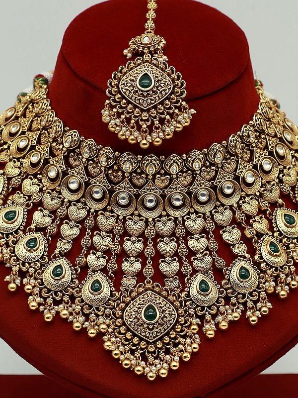 Exotic India Heavy Bridal Necklace Set With Studded Kundan Mangtika And Attractive Earrings