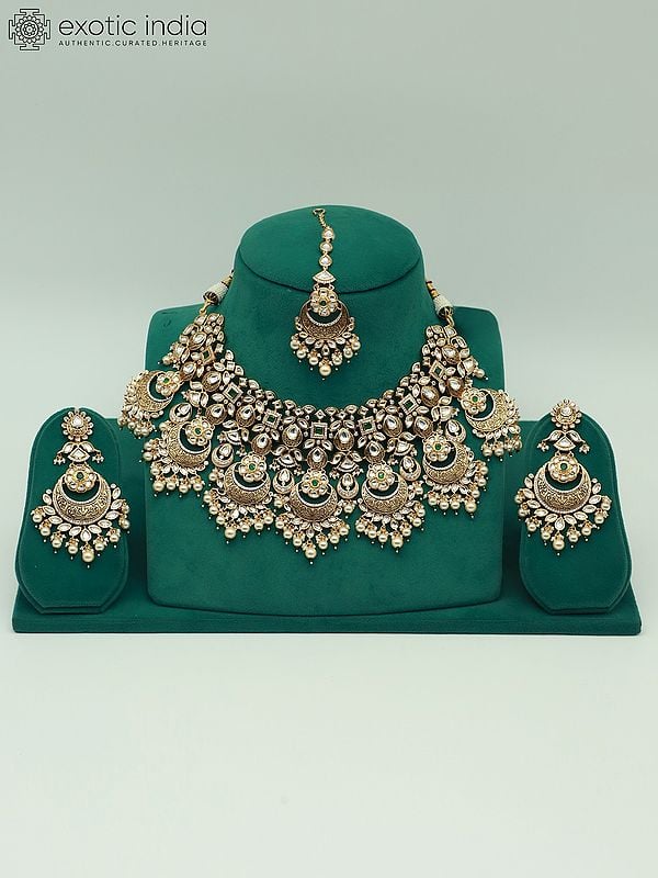 exotic india Heavy Kundan Necklace Set With Mangtika And Dangling Pearl Earring 
