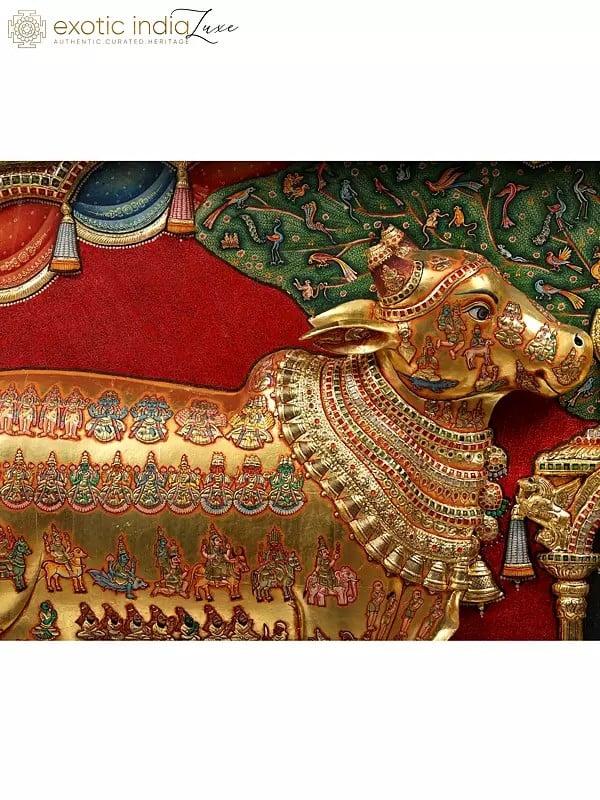 Exotic India Kamadhenu Cow With Vashist Muni Tanjore Painting With 22 Karat Gold Embossed Work | With Burma Teak Frame