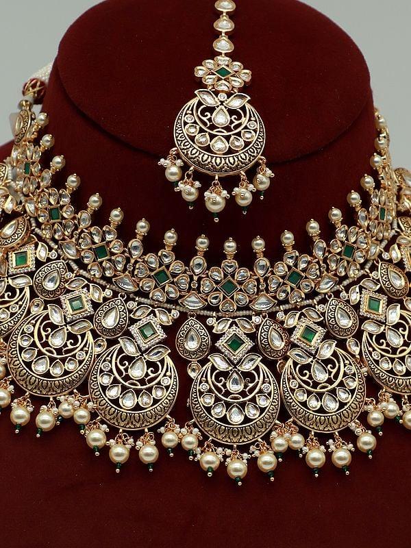 Exotic India Kundan Stone Necklace Set With Brass Carving Pearls Earrings And Mangtika 