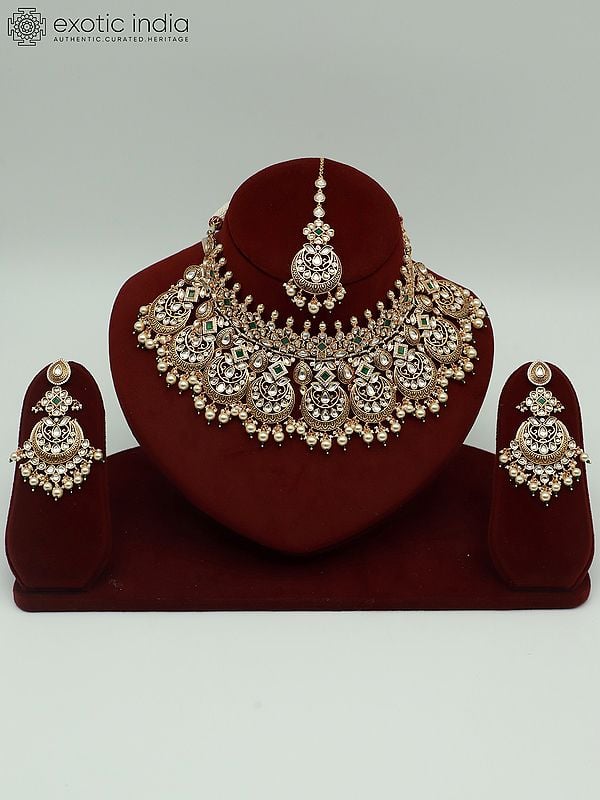 exotic india Kundan Stone Necklace Set With Brass Carving Pearls Earrings And Mangtika 